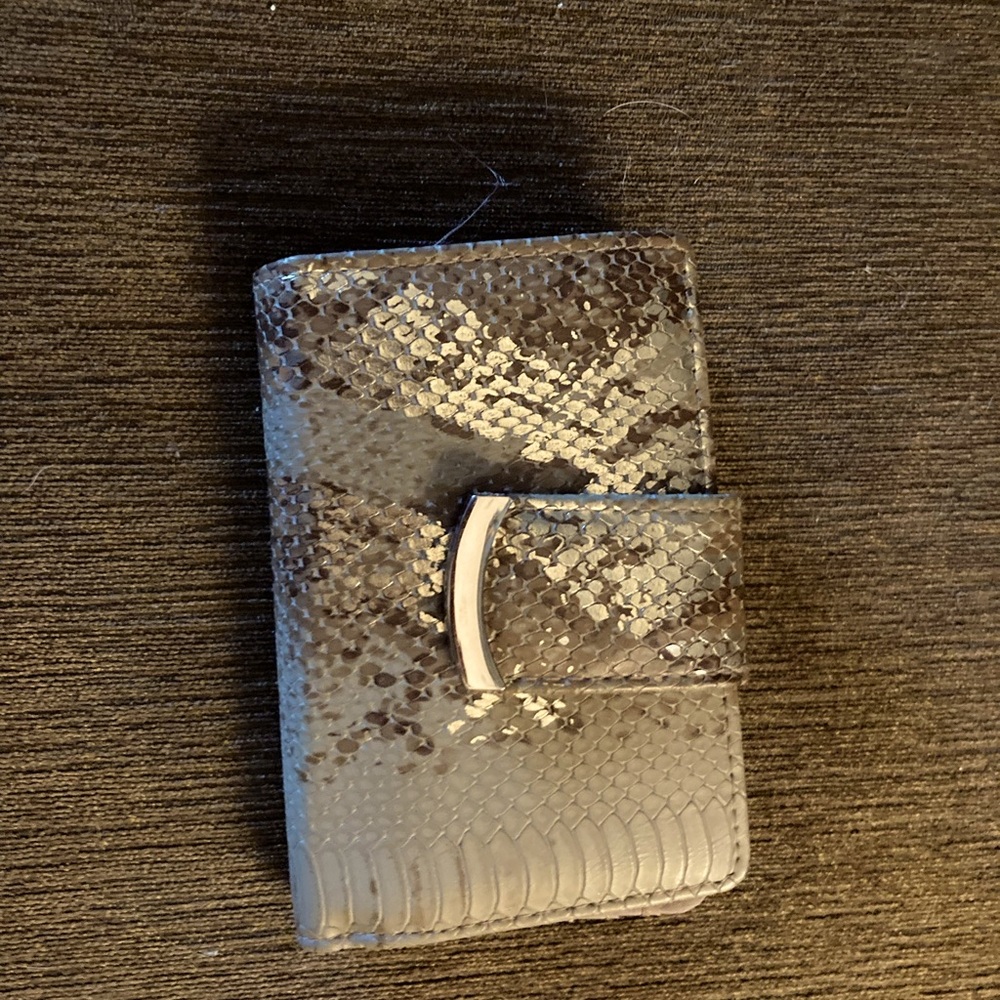 Wallet hardly used. Gold & tan. Can store many cards and change.